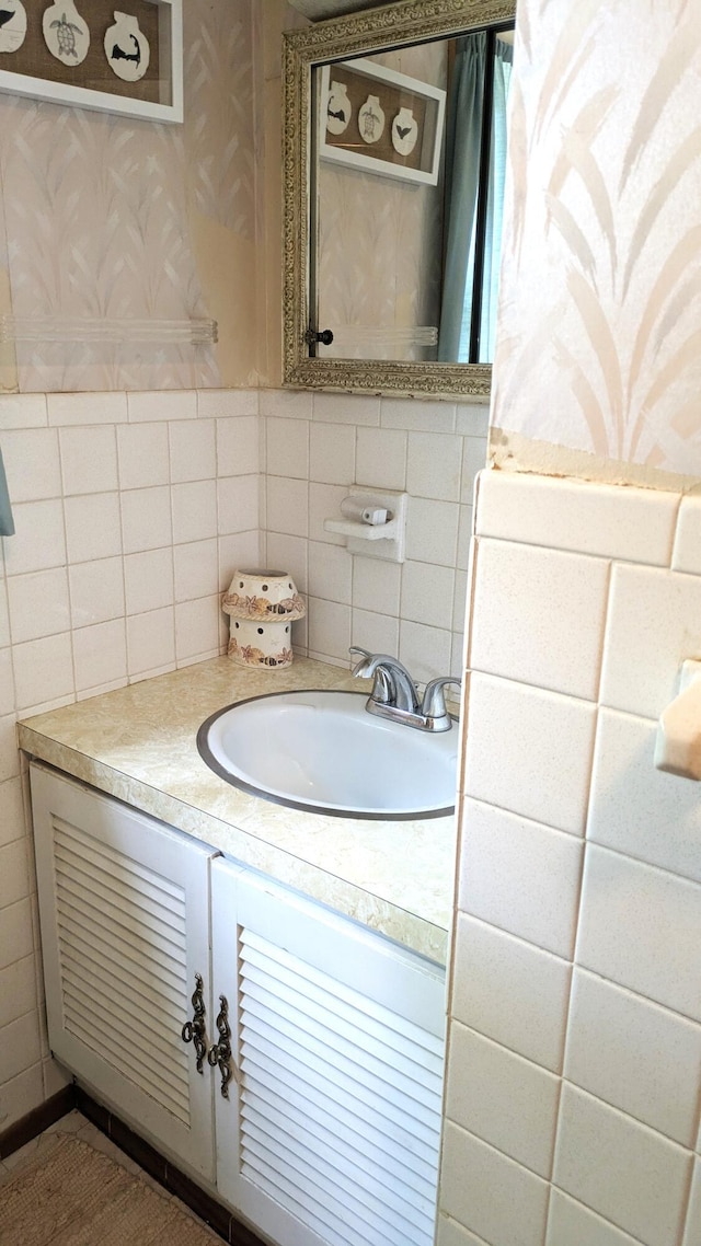 13 Pilgrim Ln, Eastham, MA 02642 - bathroom with wallpapered walls, vanity, and tasteful backsplash