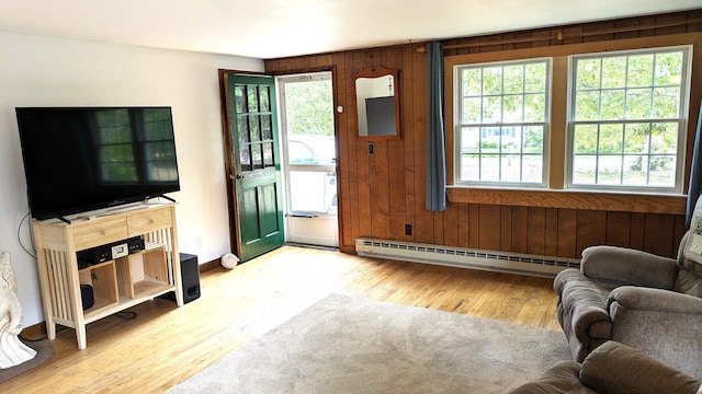 13 Pilgrim Ln, Eastham, MA 02642 - living room featuring a baseboard heating unit, wood finished floors, plenty of natural light, wooden walls, and baseboards