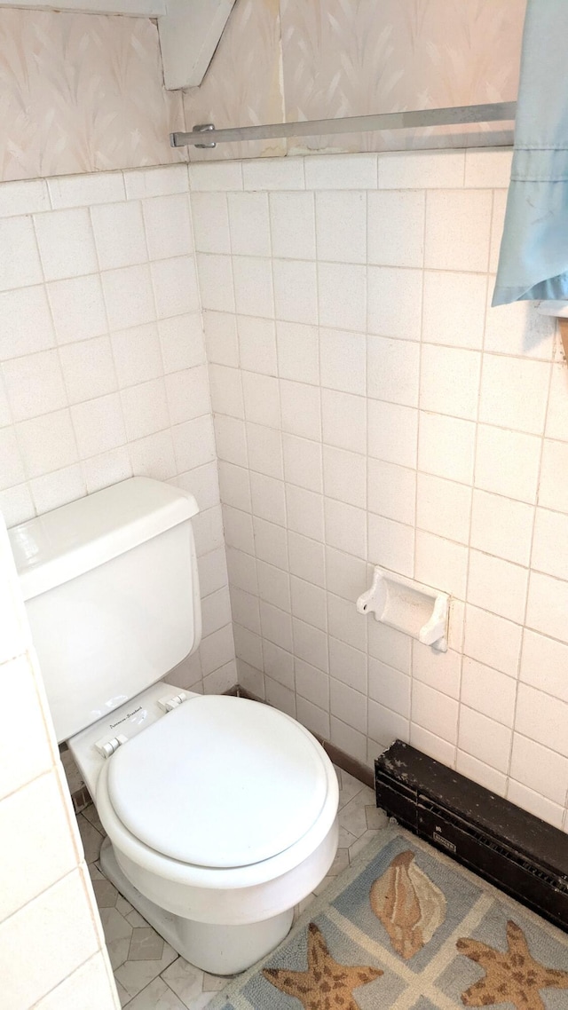 13 Pilgrim Ln, Eastham, MA 02642 - bathroom featuring toilet, tile walls, tile patterned flooring, and wallpapered walls
