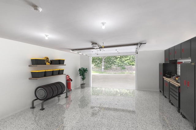 garage featuring baseboards and a garage door opener