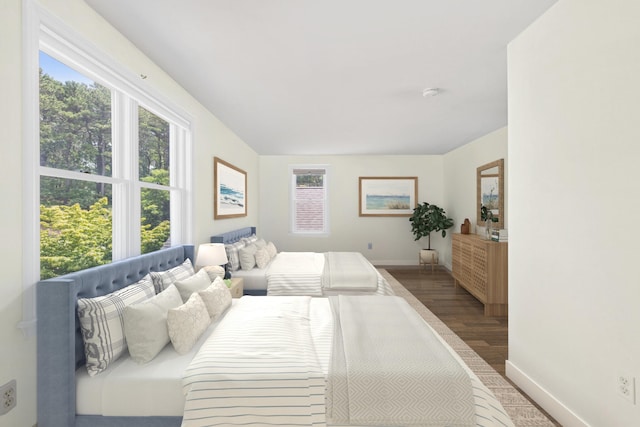 bedroom with baseboards and wood finished floors