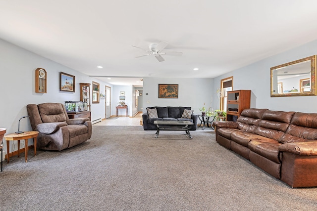 living area with a baseboard heating unit, recessed lighting, a ceiling fan, and light colored carpet