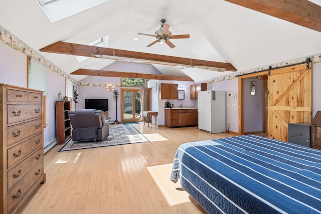 bedroom with freestanding refrigerator, lofted ceiling with skylight, a baseboard radiator, and light wood-style floors
