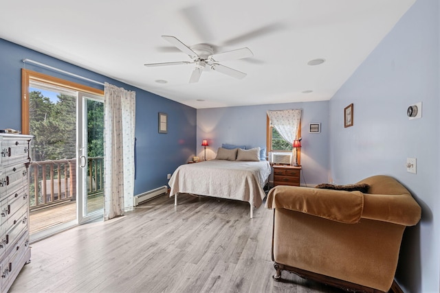 bedroom featuring multiple windows, light wood-style flooring, a baseboard heating unit, and access to outside