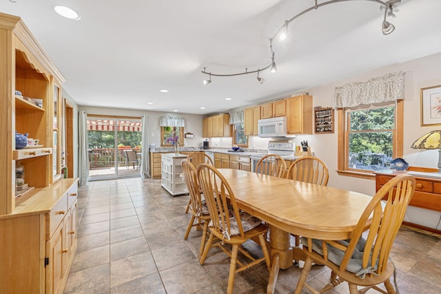 dining area with recessed lighting and light tile patterned floors
