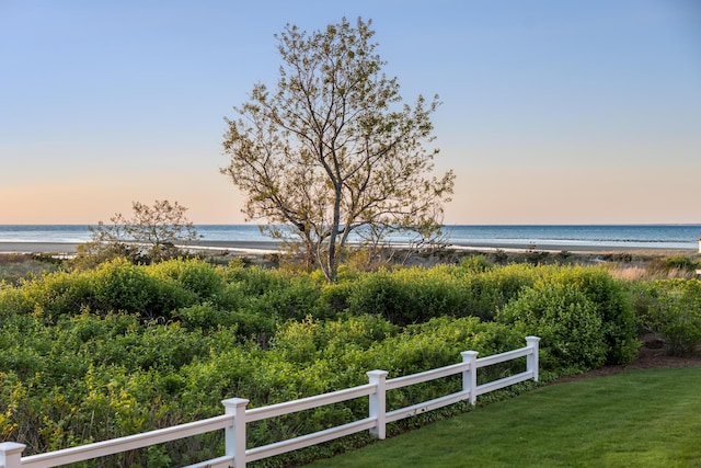 water view featuring fence and local beach