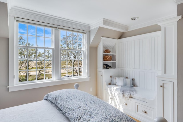 bedroom with multiple windows and crown molding