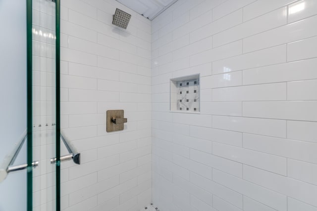 bathroom with a tile shower