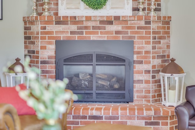 interior details featuring a brick fireplace