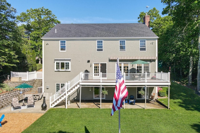 back of property featuring a patio, a yard, a deck, and central air condition unit