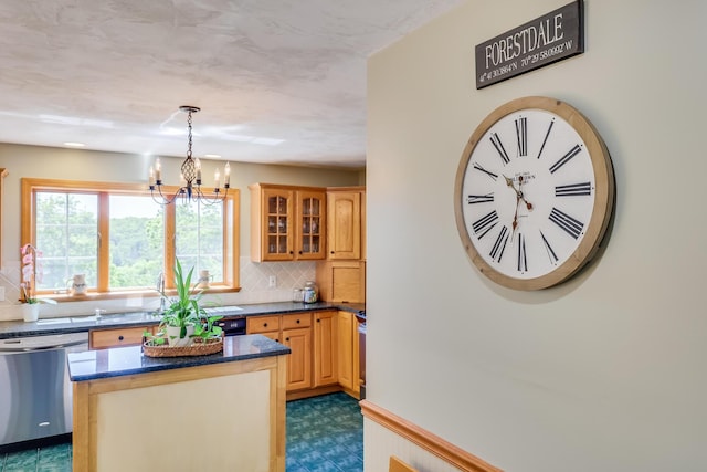 kitchen featuring tasteful backsplash, range, a center island, hanging light fixtures, and dishwasher