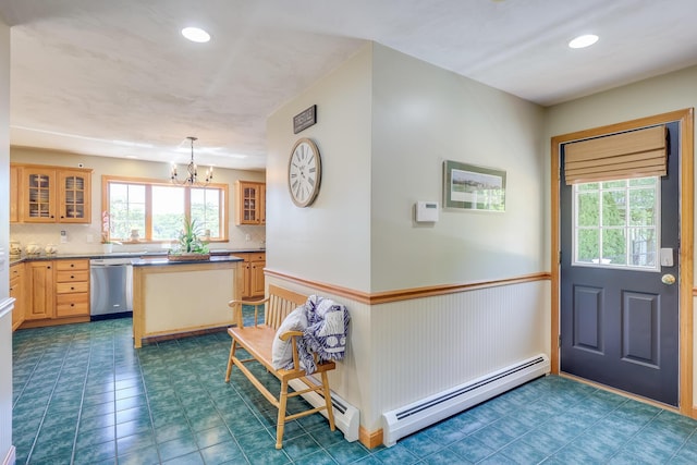 kitchen featuring an inviting chandelier, stainless steel dishwasher, a baseboard radiator, pendant lighting, and decorative backsplash