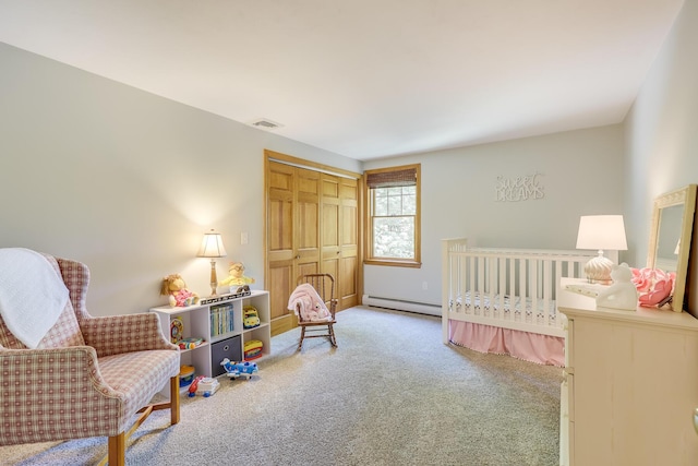 carpeted bedroom with a baseboard radiator and a closet