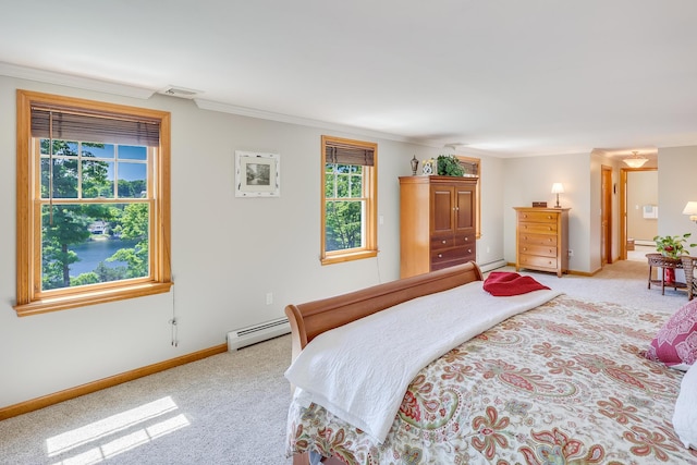 carpeted bedroom with ornamental molding and a baseboard heating unit