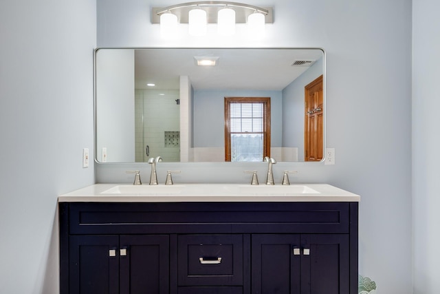 bathroom with a shower with door and vanity