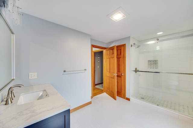 bathroom with vanity and a shower with shower door