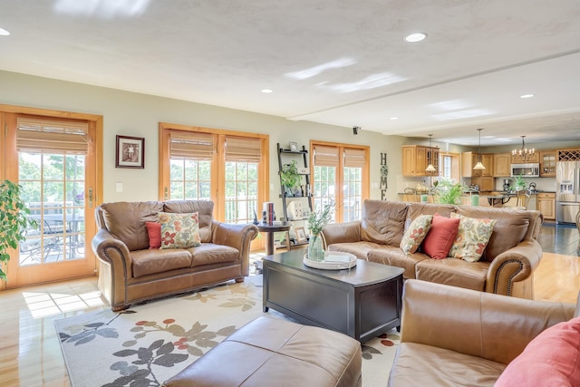 living room with a chandelier and light hardwood / wood-style floors