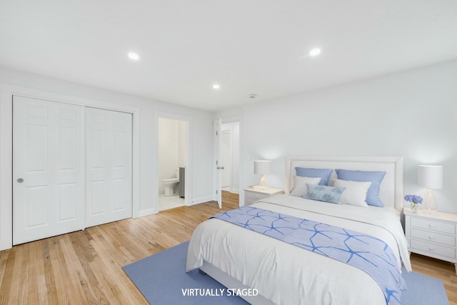 bedroom with ensuite bathroom, wood finished floors, recessed lighting, a closet, and baseboards