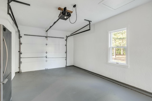 garage with a garage door opener and freestanding refrigerator