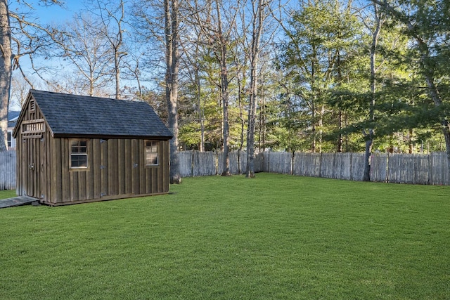 view of yard with a fenced backyard, a shed, and an outdoor structure