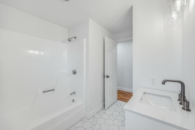 bathroom with tile patterned floors, tub / shower combination, vanity, and baseboards