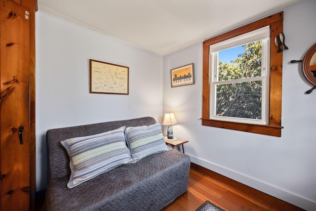 living area with wood finished floors and baseboards