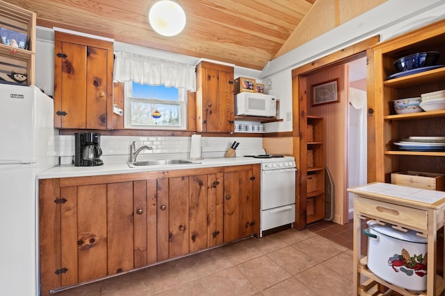 kitchen with open shelves, brown cabinetry, a sink, and white appliances