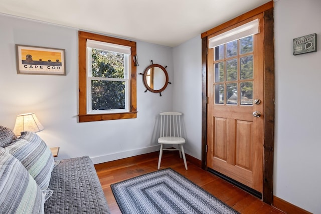interior space with wood finished floors and baseboards