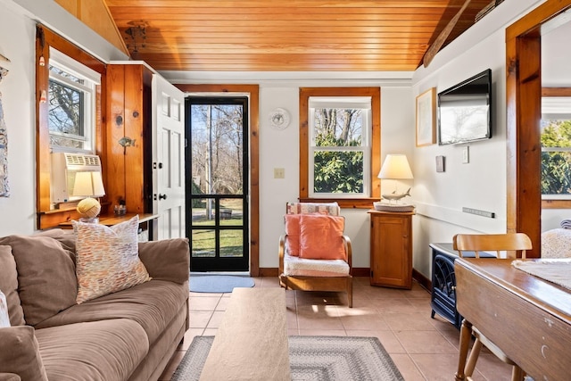 living area with cooling unit, wooden ceiling, baseboards, and light tile patterned floors