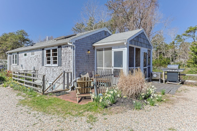 82 Shore Rd Unit 6, Truro, MA 02666 - back of property featuring roof with shingles and a sunroom