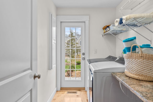 36 Pheasant Cove Cir, Yarmouth Port, MA 02675 - washroom featuring washing machine and dryer, healthy amount of natural light, light wood finished floors, and baseboards
