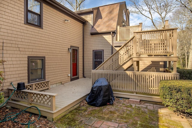 back of property featuring a shingled roof, stairway, a deck, and a gambrel roof