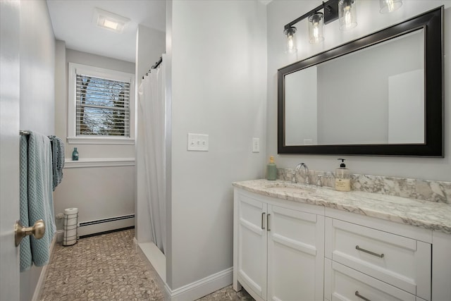 bathroom featuring a shower with curtain, baseboards, baseboard heating, and vanity