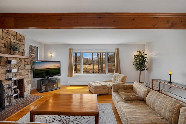 living area featuring beam ceiling, a fireplace, light wood-style flooring, baseboard heating, and baseboards