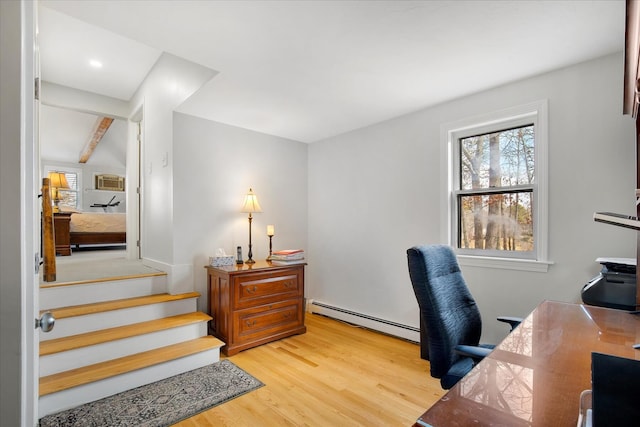 home office featuring light wood finished floors and a baseboard heating unit