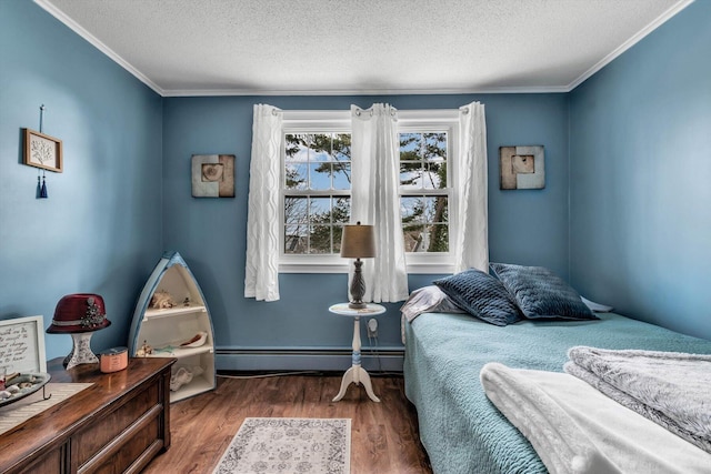 bedroom with crown molding, a baseboard heating unit, a textured ceiling, and dark hardwood / wood-style flooring