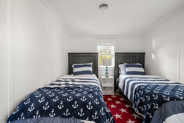 carpeted bedroom with visible vents and ornamental molding