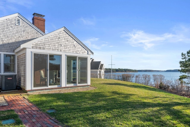 exterior space with a sunroom, central AC, and a water view