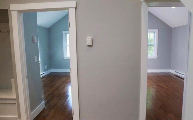 hall featuring lofted ceiling, a baseboard radiator, baseboards, and dark wood finished floors