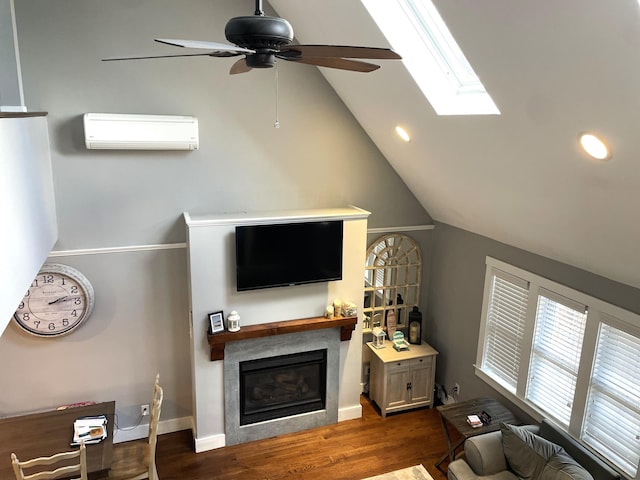 16 Regency Dr, Sagamore, MA 02561 - living area featuring a wall unit AC, wood finished floors, a glass covered fireplace, ceiling fan, and lofted ceiling