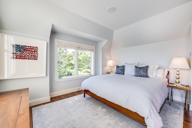 bedroom with baseboards and wood finished floors