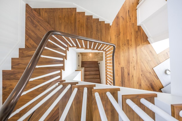 staircase with wood walls