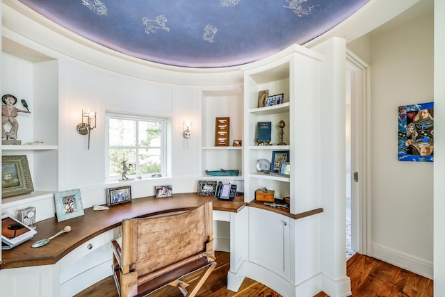 office space with built in desk and dark wood finished floors