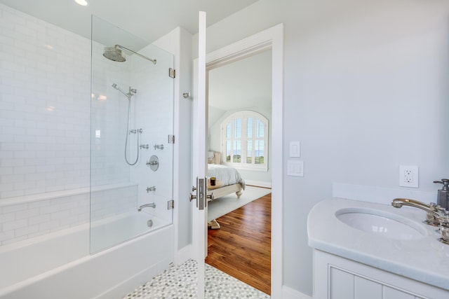 ensuite bathroom with bathing tub / shower combination, baseboards, connected bathroom, and vanity