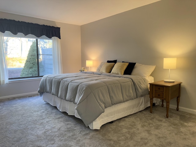 bedroom with carpet floors, visible vents, and baseboards