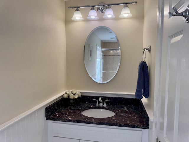 bathroom featuring a wainscoted wall and vanity