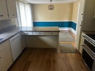 kitchen with decorative light fixtures, electric range, white cabinets, and dishwasher