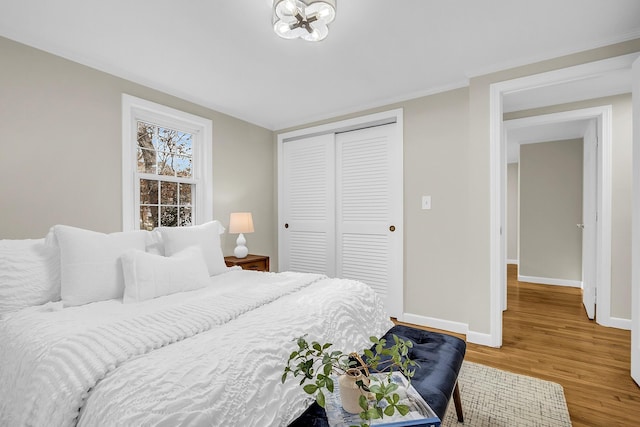 bedroom featuring hardwood / wood-style flooring and a closet