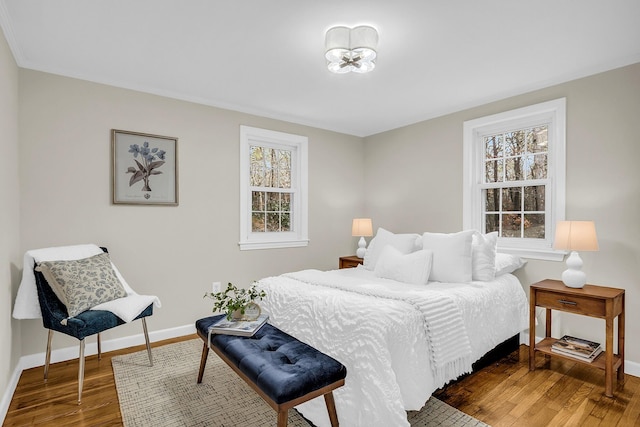 bedroom featuring dark wood-type flooring and multiple windows