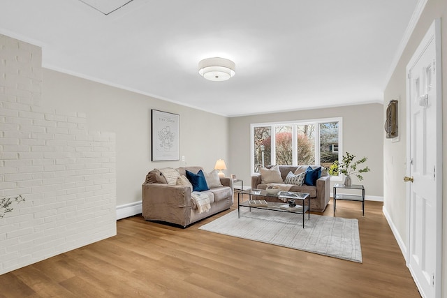 living room with light wood-type flooring and ornamental molding